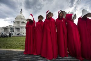 Protesters dressed as Handmaids
